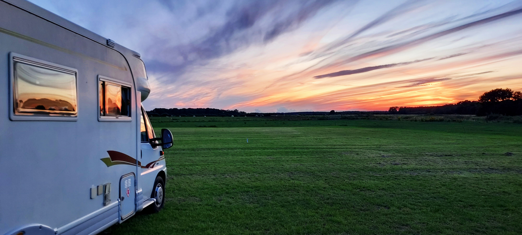 A sunset scene with a motorhome. At a U.K. Naturist Club event held by Suntreckers.