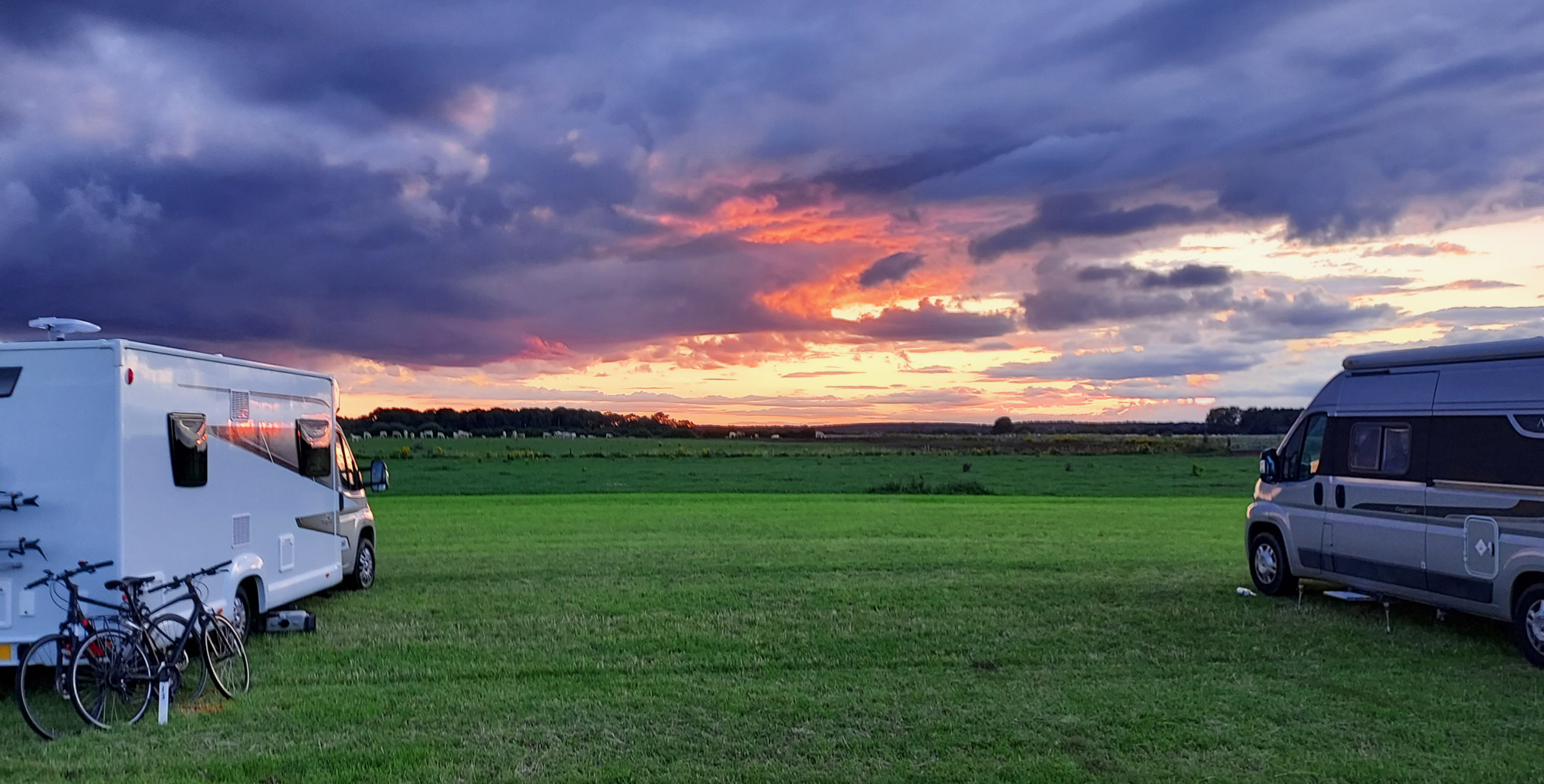 A sunset scene with motorhomes. At a U.K. Naturist Club event held by Suntreckers.